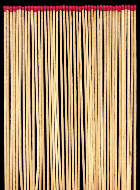 Long wooden matches on a black background - Photo, Image