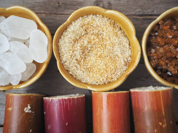 Zucchero bianco e marrone in ciotole di bambù su vecchio fondo di legno
 - Foto, immagini