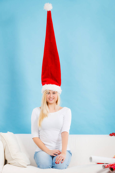 Woman wearing windblown crazy santa hat - Photo, image