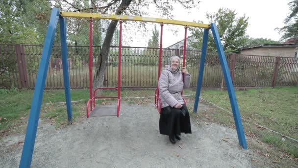 Old grandmother on a swing. - Záběry, video