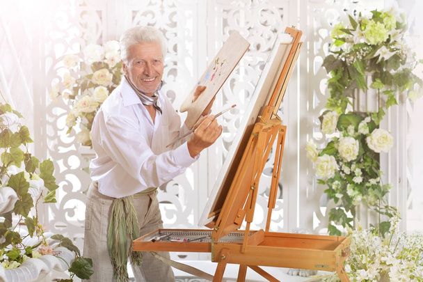 Senior man drawing picture  - Fotó, kép