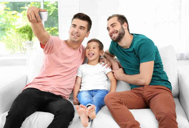 Male gay couple with foster son taking selfie. Adoption concept - Fotó, kép