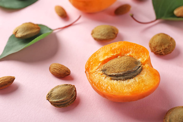 Half of apricot and kernels on color background - Foto, imagen