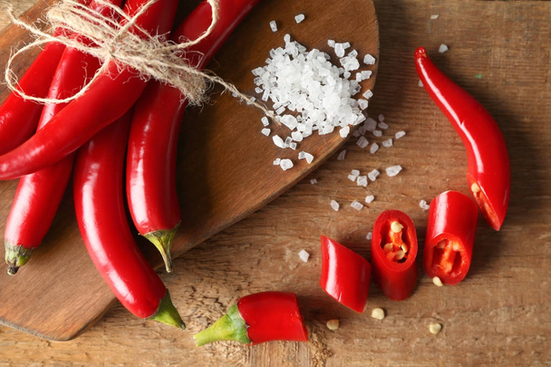 Chili peppers on wooden board - Zdjęcie, obraz