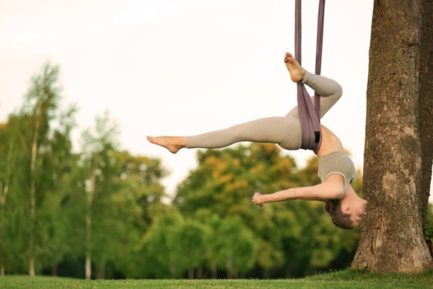 Woman practicing aerial yoga  - Foto, imagen