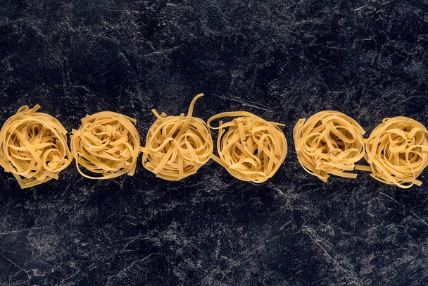 pasta nests in row - Φωτογραφία, εικόνα