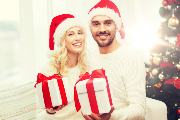 happy couple at home with christmas gift boxes - Фото, зображення