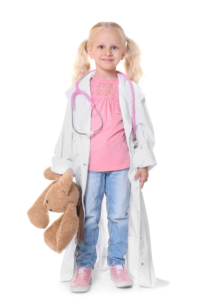 Little girl in medical coat with bunny isolated on white - 写真・画像