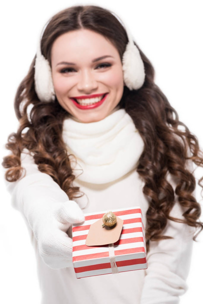 woman in winter earmuffs holding gift - Φωτογραφία, εικόνα
