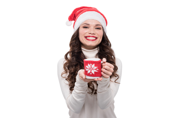 Woman in santa hat wtih coffee cup - Photo, Image