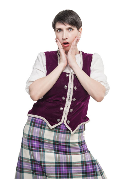 Woman in traditional Scottish costume surprised - Foto, afbeelding