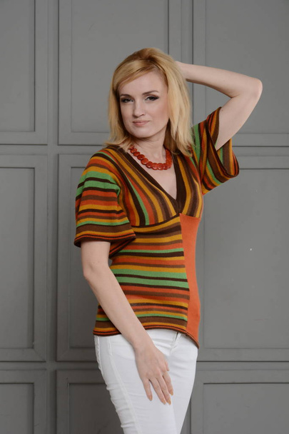 Beautiful woman dressed with 1970s style. Warm colors - Fotó, kép
