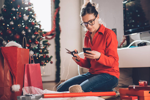 Woman Wrapping Gifts At Home - Photo, Image