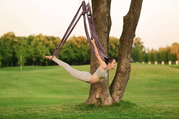 Woman practicing aerial yoga  - Fotó, kép