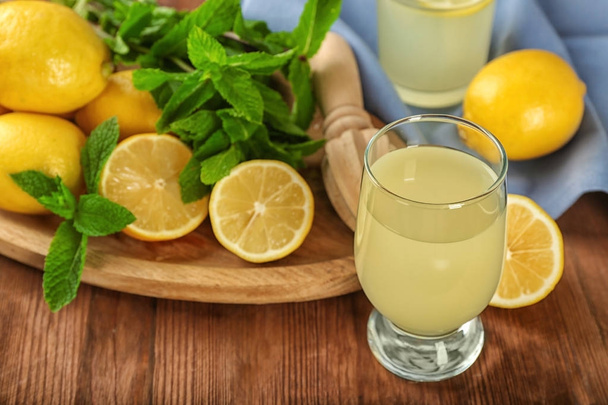 Beautiful composition with glass of fresh lemon juice on table - Φωτογραφία, εικόνα