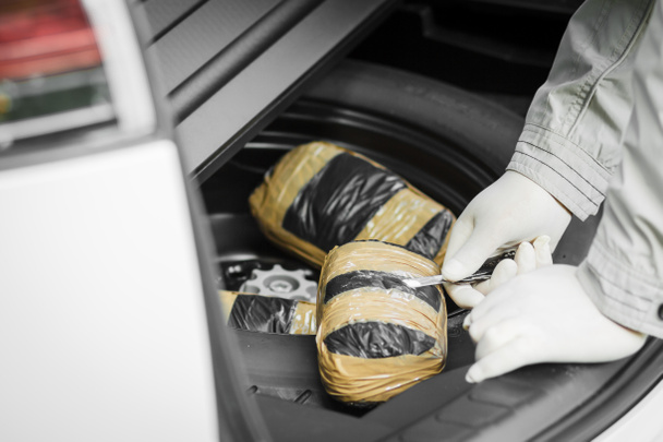 A packet of drugs was found in the spare wheel of the car. Drugs - Photo, Image