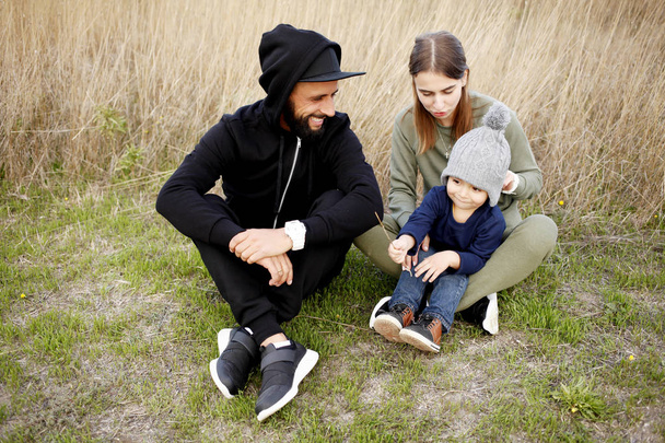 happy family sitting on meadow  - Фото, изображение
