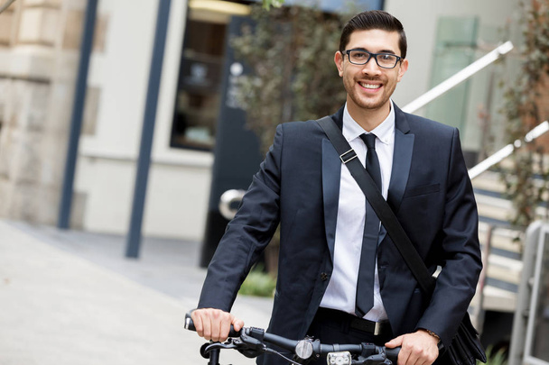 Young businessmen with a bike - Фото, изображение