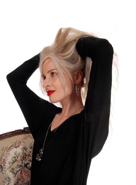 Blond woman messing her hair - Valokuva, kuva