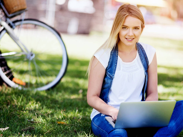 Woman working outdoors in a meadow with laptop - Zdjęcie, obraz
