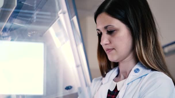woman in white uniform working in modern Laboratory  - Materiaali, video