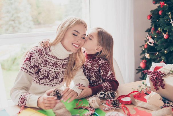 Little lovely blonde with her mommy are hugging, doing handcraft - Foto, Imagen