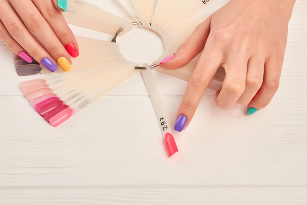 Female finger choosing nail color. - Фото, зображення