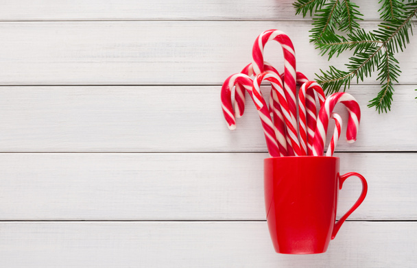 Joyful christmas background with traditional candy cane lollipops - Foto, afbeelding