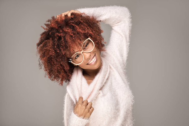Happy woman with afro hairstyle smiling. - 写真・画像