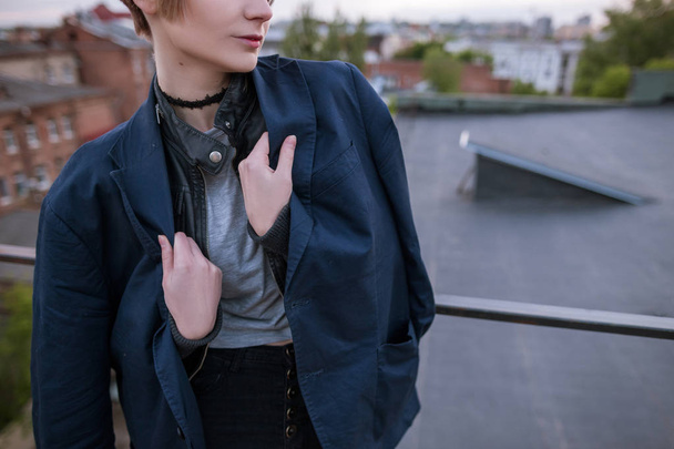 Enigmatic young woman wearing in mans jacket - 写真・画像