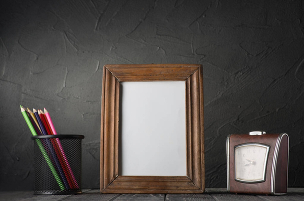 colored pencils, empty frame and clock - 写真・画像
