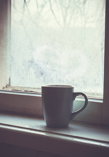 cup of tea on the windowsill. selective focus.   - Photo, Image