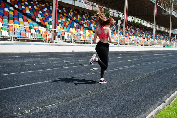 Fitness sporty girl in sportswear at stadium outdoor sports. Hap - Fotoğraf, Görsel