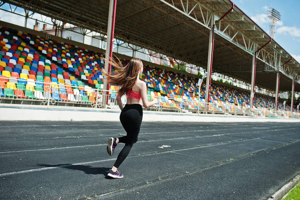 Fitness sporty girl in sportswear at stadium outdoor sports. Hap - Zdjęcie, obraz