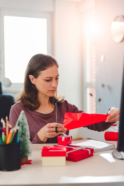 Woman Wrapping Christmas Gifts - 写真・画像