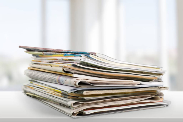 Pile of printed newspapers on light background  - Foto, imagen