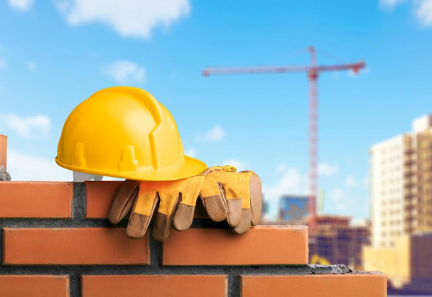 yellow helmet with equipment on construction background - Photo, Image