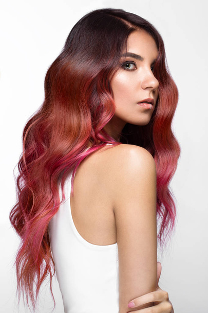 Beautiful pink-haired girl in move with a perfectly curls hair, and classic make-up. Beauty face. - Foto, Imagem