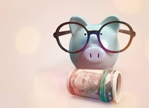 blue piggy bank with money on light background - Foto, Bild