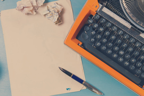 Workspace with vintage orange typewriter - Foto, Imagen