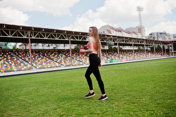 Fitness sporty girl in sportswear at stadium outdoor sports. Hap - Zdjęcie, obraz