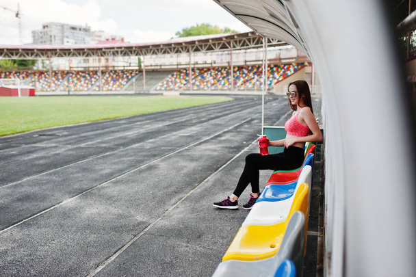 Fitness sporty girl in sportswear at stadium outdoor sports. Hap - Photo, image