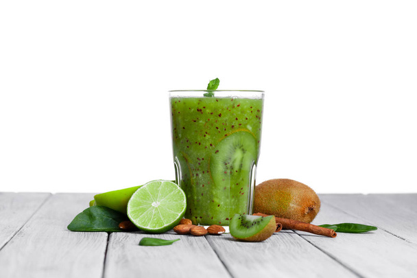 top view of glass of smoothie from kiwi, apple, and lime with mint on a gray wooden background. - 写真・画像