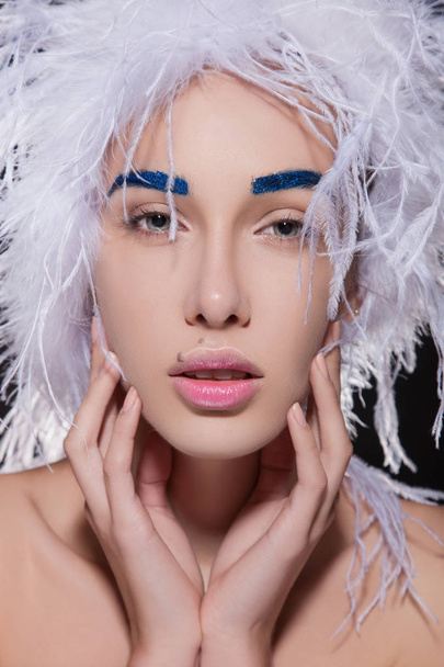 Woman in fluffy hat and blue eyebrows - Zdjęcie, obraz