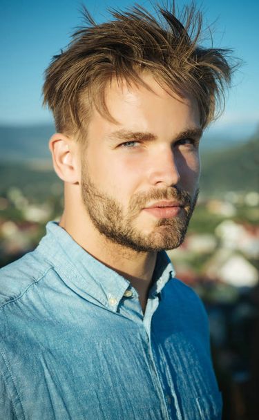 Man with bearded face and haircut posing in blue shirt - Foto, afbeelding