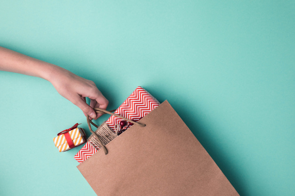 hand holding paper bag with gifts - Photo, Image