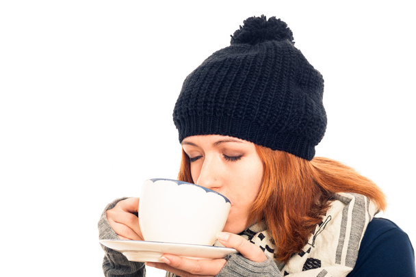 Woman in winter clothes drinking hot drink - Photo, Image
