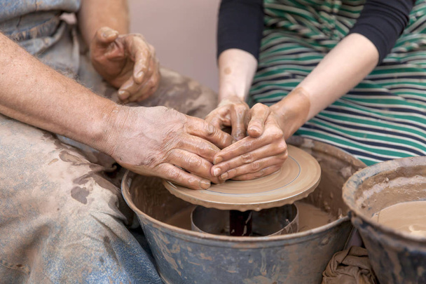 Fabrication de poterie. Mains travaillant sur la roue de poterie
 - Photo, image