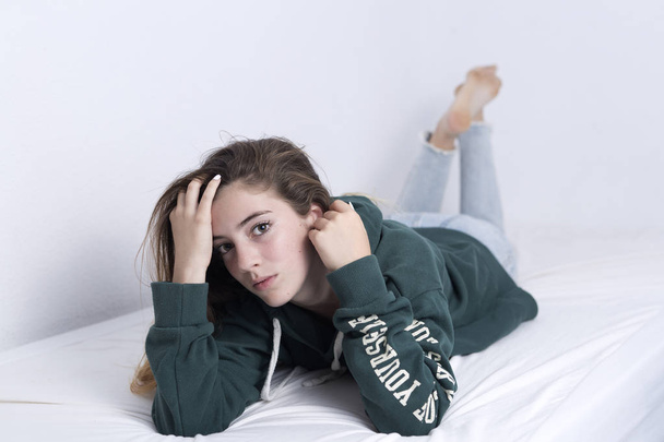 15-year-old adolescent lying on her bed - Photo, Image