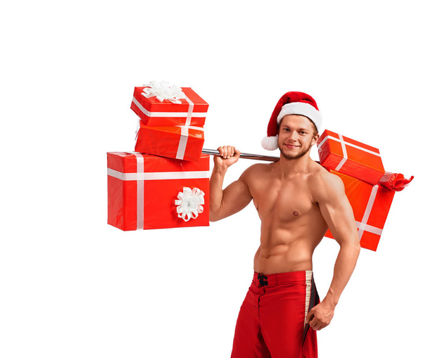 Fit Naked Santa Claus with a barbell full of presents - Fotoğraf, Görsel
